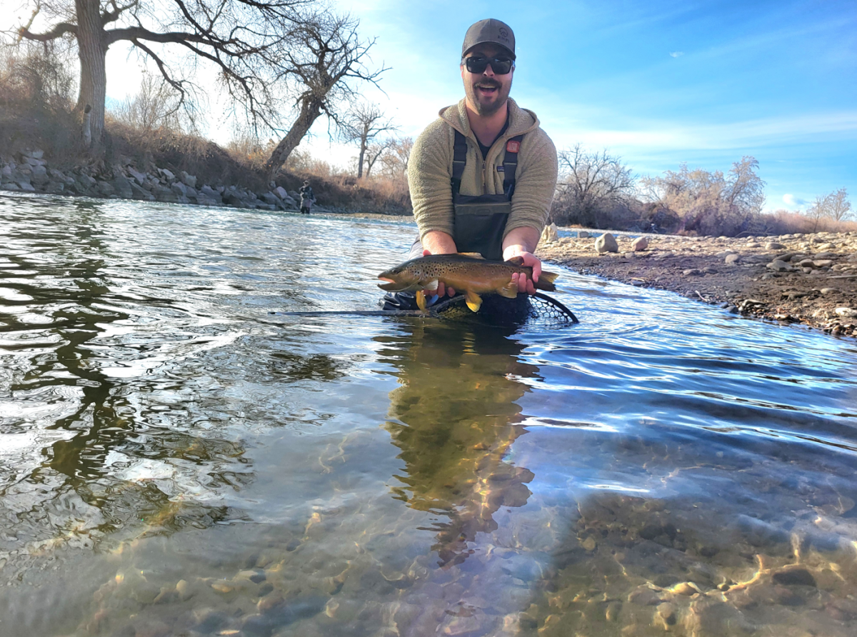 sam hoding fish in stream