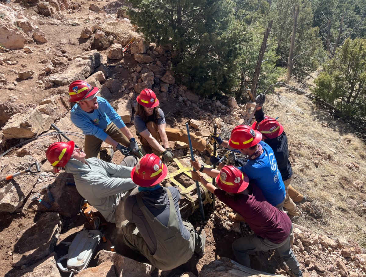 RMFI crew moving a rock together at Piggy Bank, 2024. 
