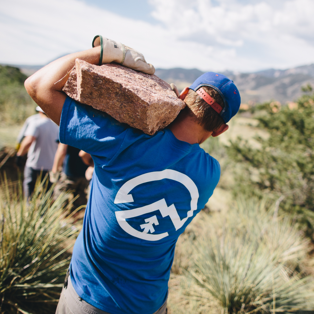 Volunteer moving slab of granite