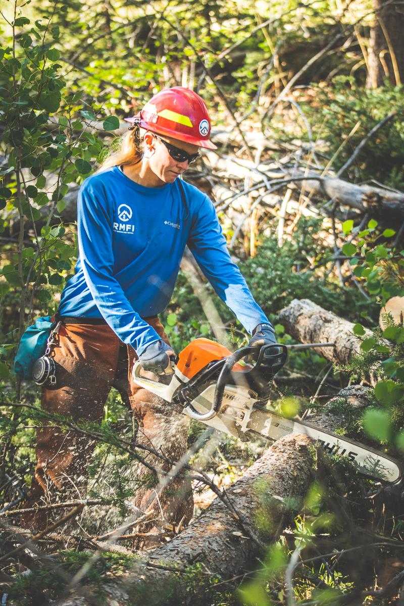 RMFI staff using a chainsaw