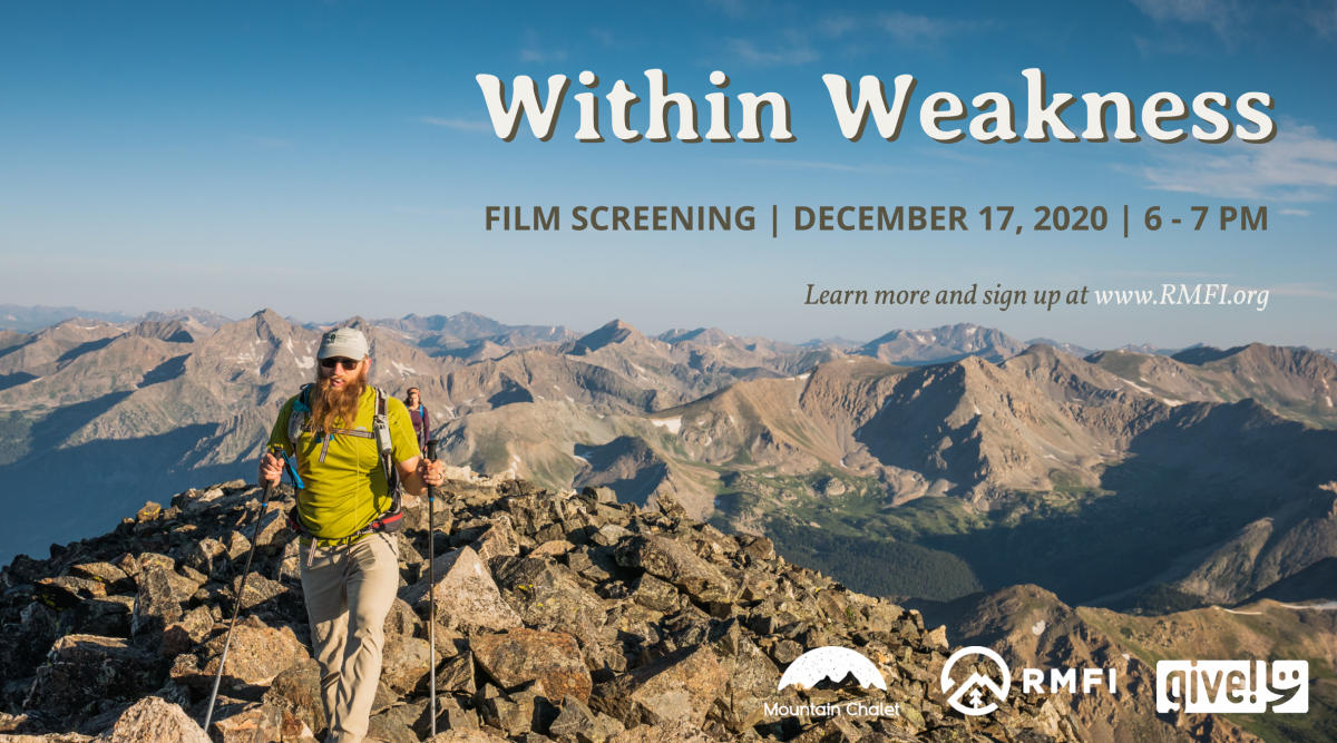 Wesley hiking above tree line with mountains all around him